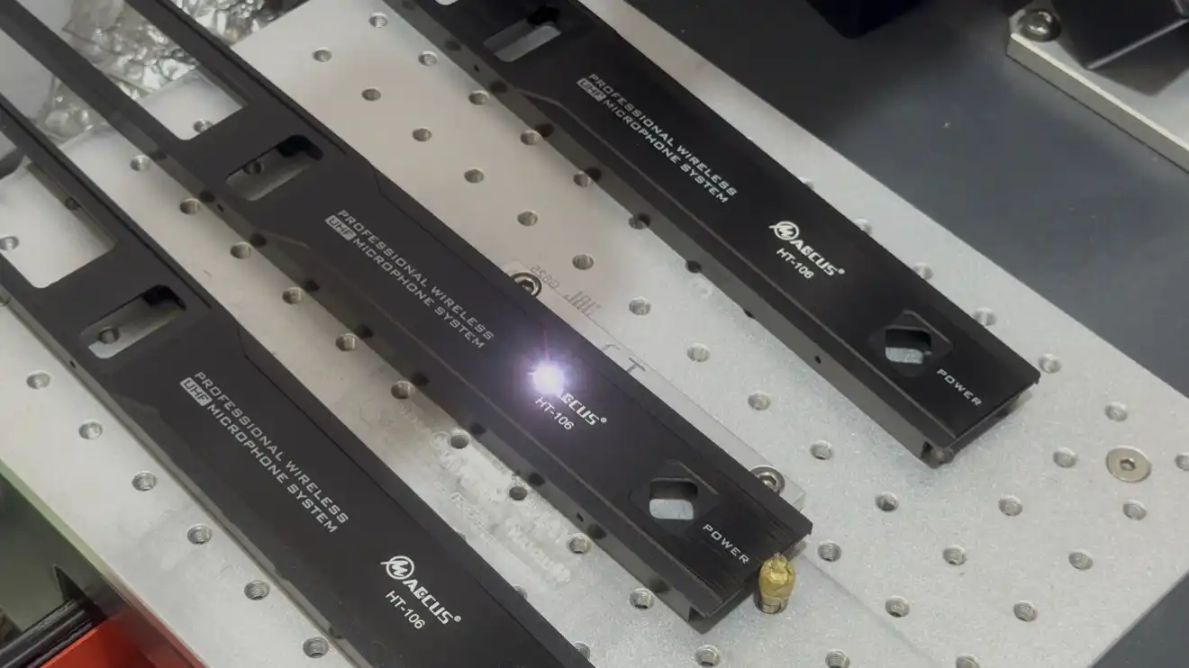 Close-up of the Maccus OEM laser engraving process for custom client logos on metal microphone chassis
